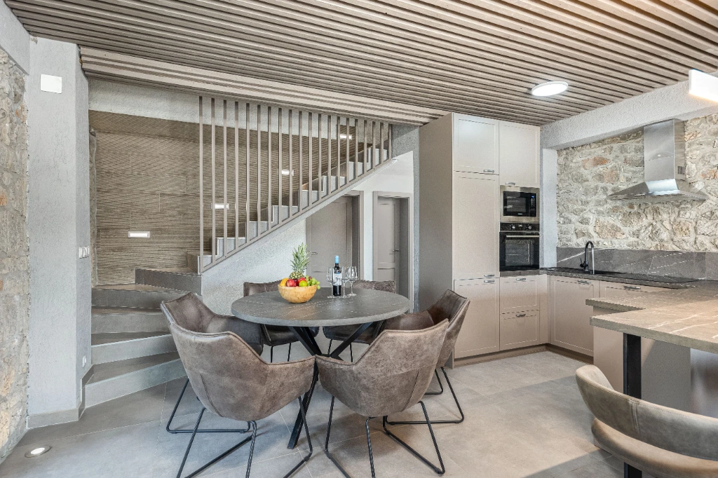 Stone and wood kitchen and dining area in the Red Apartment
