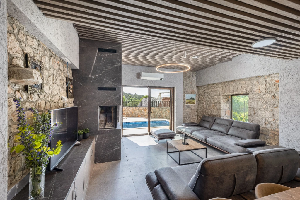 Spacious stone-walled living room in the Blue Apartment