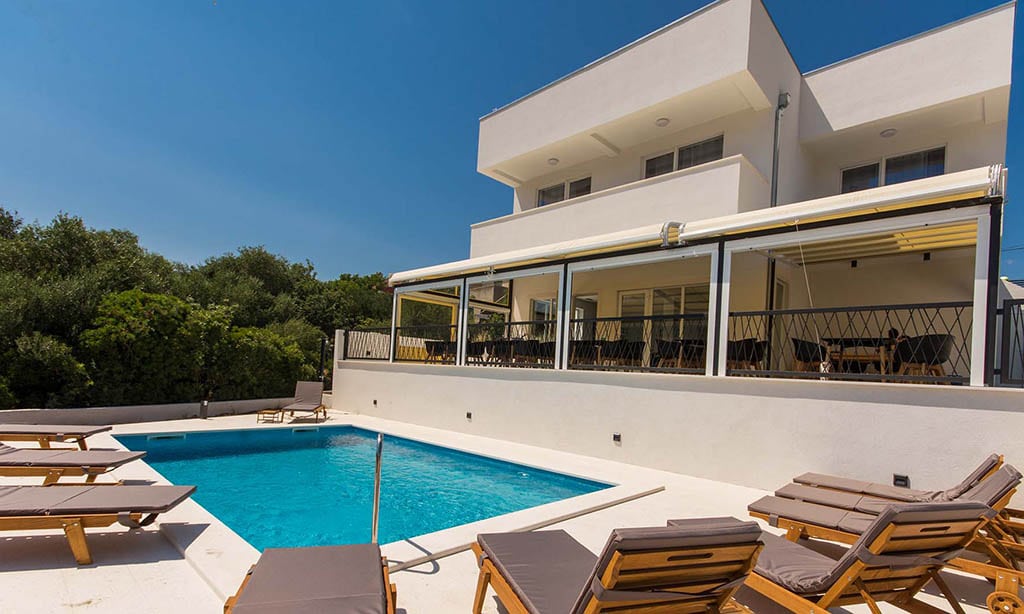 Villa Casablanca and its outdoor pool under a clear blue sky